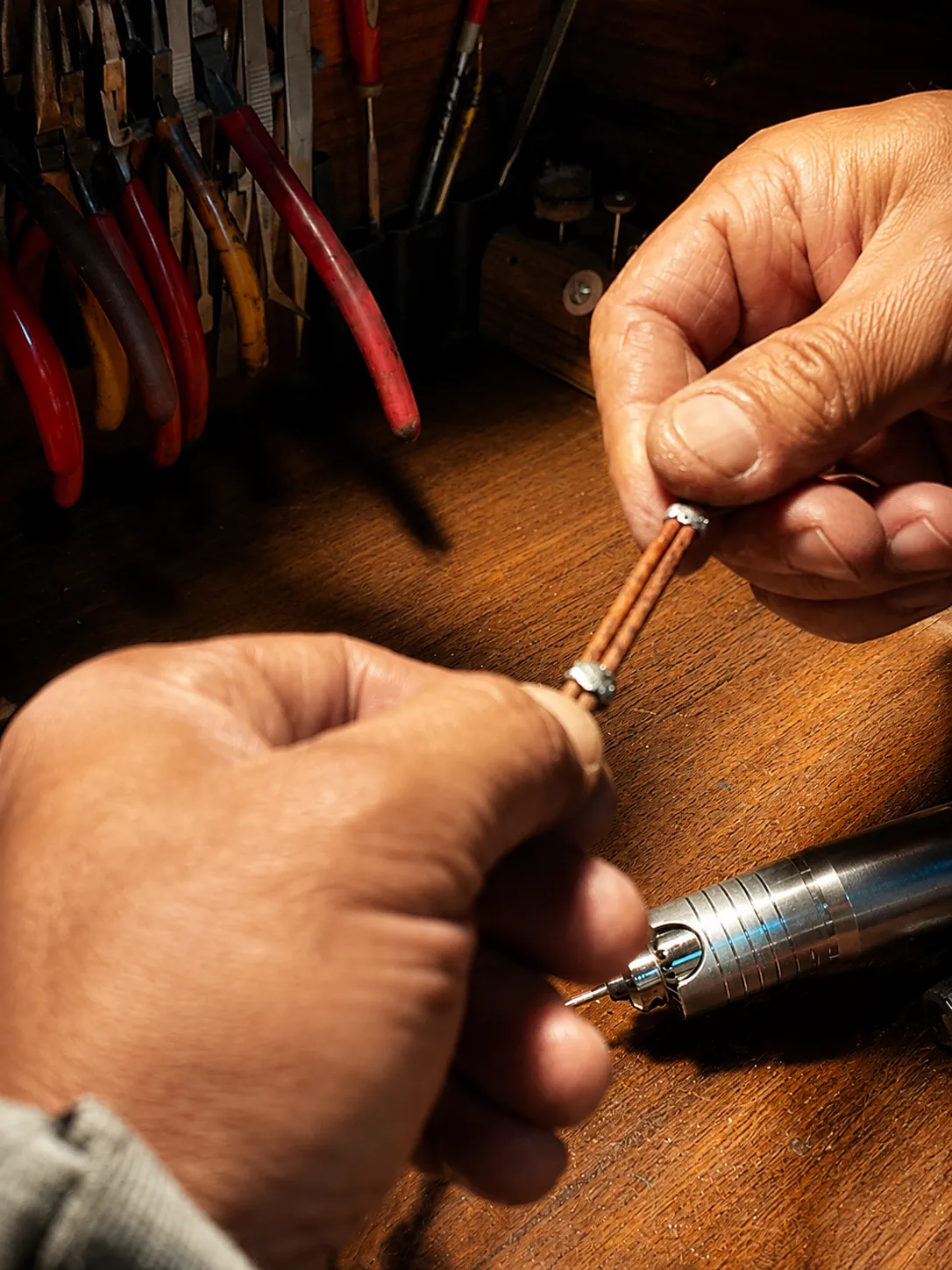 Leather strap being prepared and shaped by hand