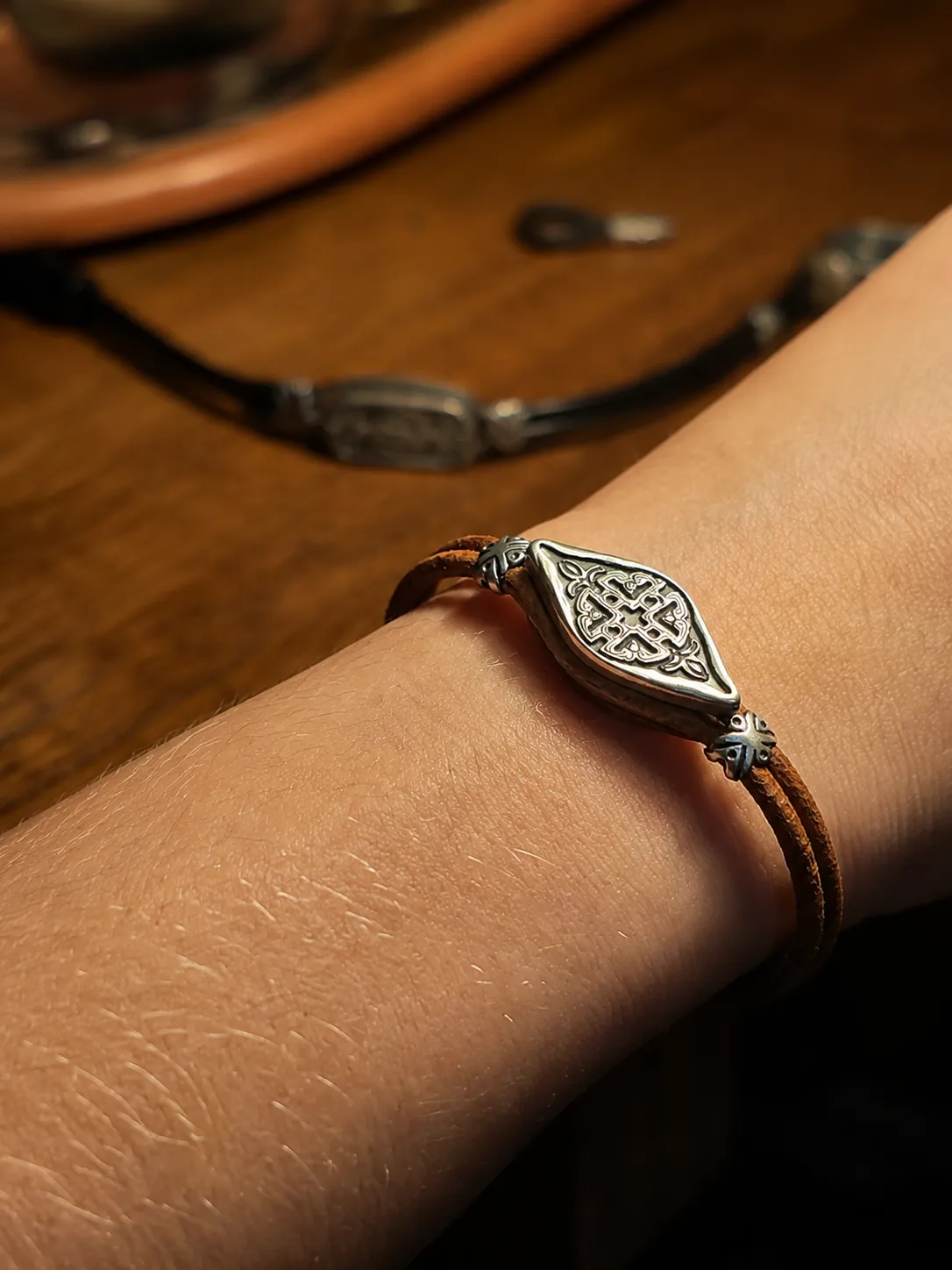 Handcrafted bu-neba silver bracelet worn on a wrist, front view